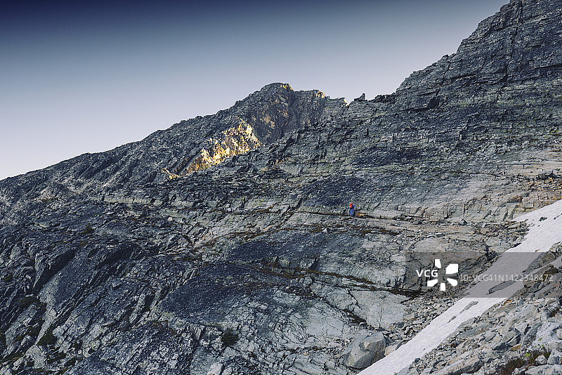 登山者奋力攀登山脊图片素材