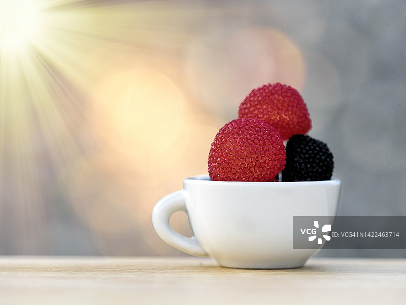 阳光下的草莓味软糖杯图片素材