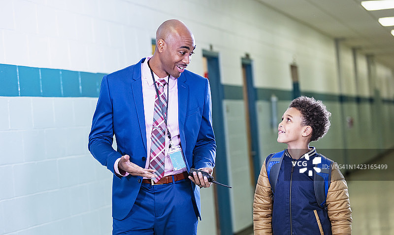 小学生和老师在学校走廊里图片素材