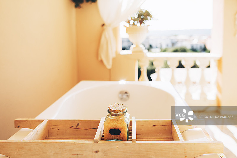 阳光明媚的露台上放着浴盐的浴缸图片素材