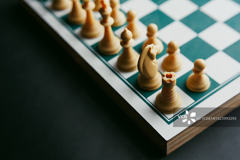 深色背景下的国际象棋棋盘和棋子特写图片素材
