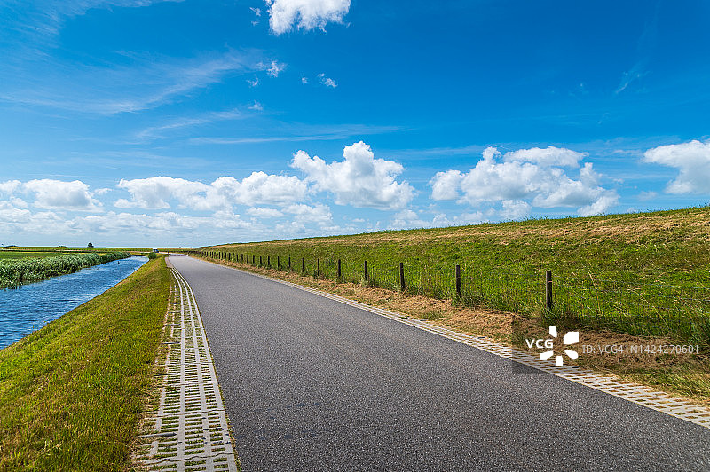 阳光明媚的运河旁乡村公路图片素材