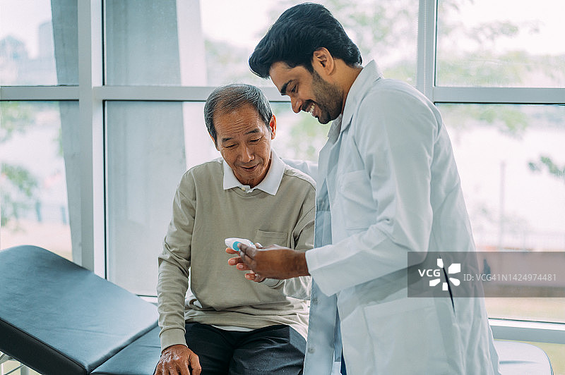 印度裔医生在诊所向患者展示检查结果图片素材