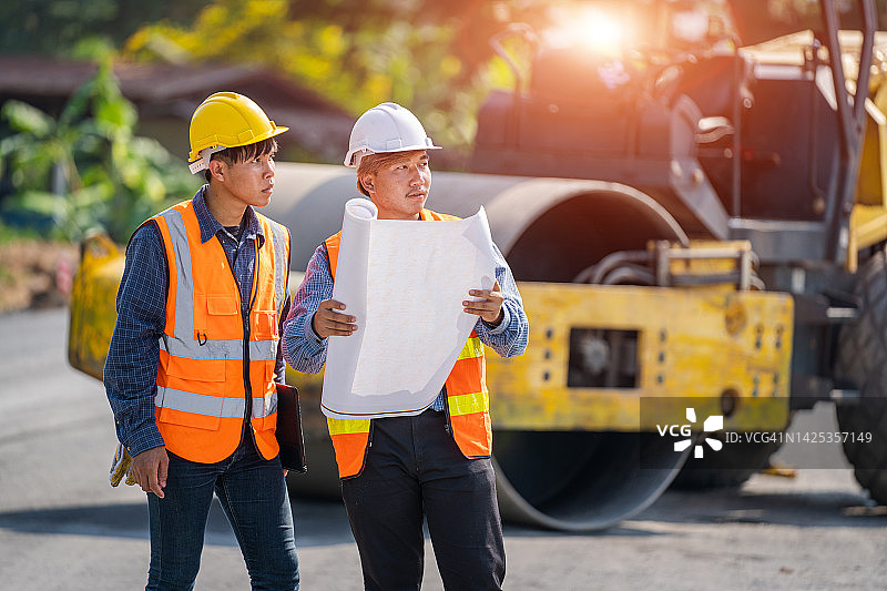工程师在城市街道上操作铲车进行道路施工图片素材