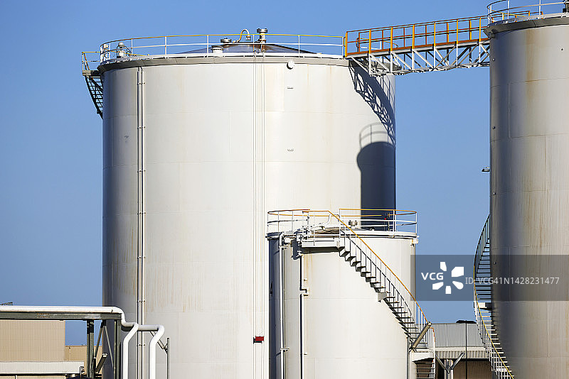 蓝色天空下的工业储油罐图片素材