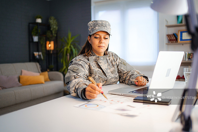 女兵在家使用笔记本电脑图片素材