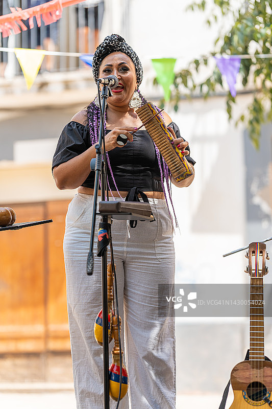 在户外舞台上表演的唱歌弹乐器的女人图片素材