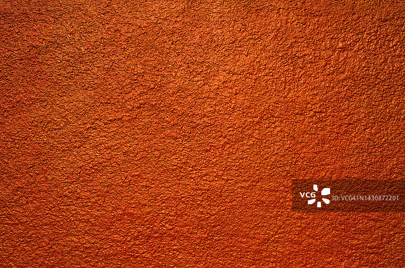 涂有鲜艳橙色的纹理灰泥墙图片素材