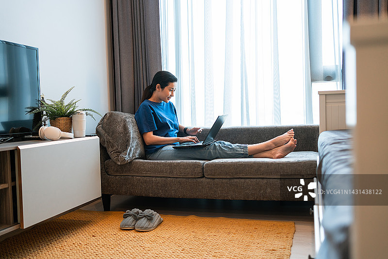 在家用笔记本电脑进行在线购物的亚洲女人图片素材