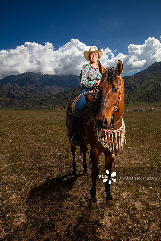 身穿碎花衬衫、头戴白色帽子的女骑手图片素材