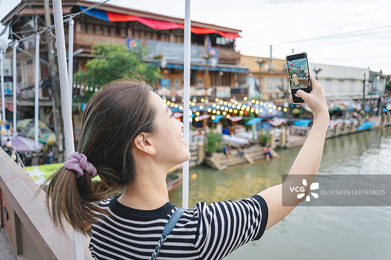 年轻女网红在安帕瓦泰国拍摄旅行视频图片素材