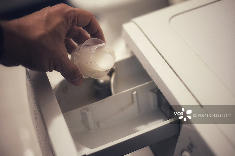 手部动作：将洗涤剂倒入洗衣机图片素材