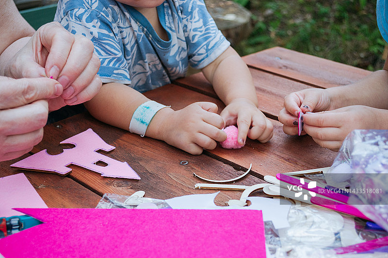 母女制作粉色剪纸装饰的特写图片素材