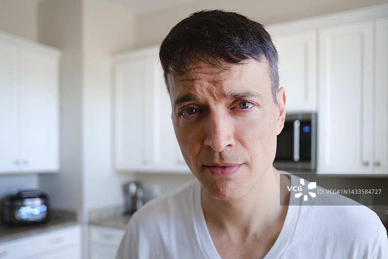 男人站在厨房里看着镜头图片素材