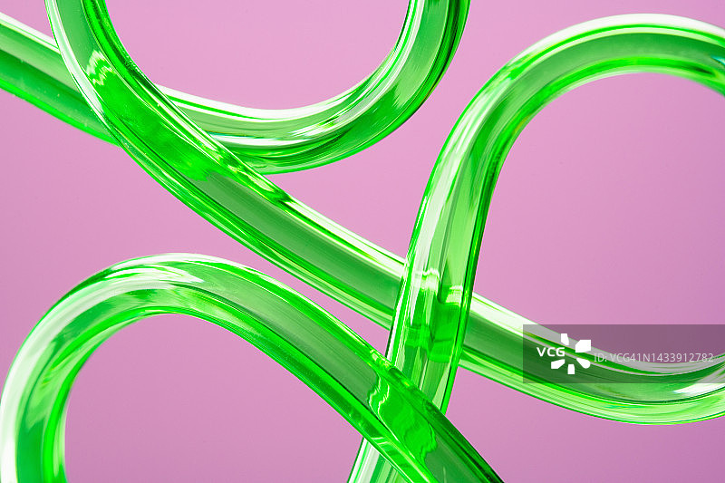 粉色抽象背景上的绿色管状物图片素材