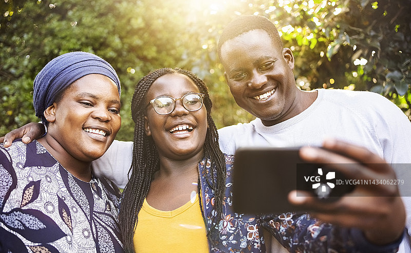 在阳光明媚的花园里自拍的非洲家庭图片素材