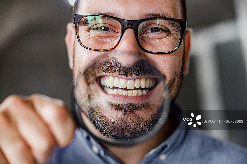 快乐的商人用放大镜玩耍的特写图片素材