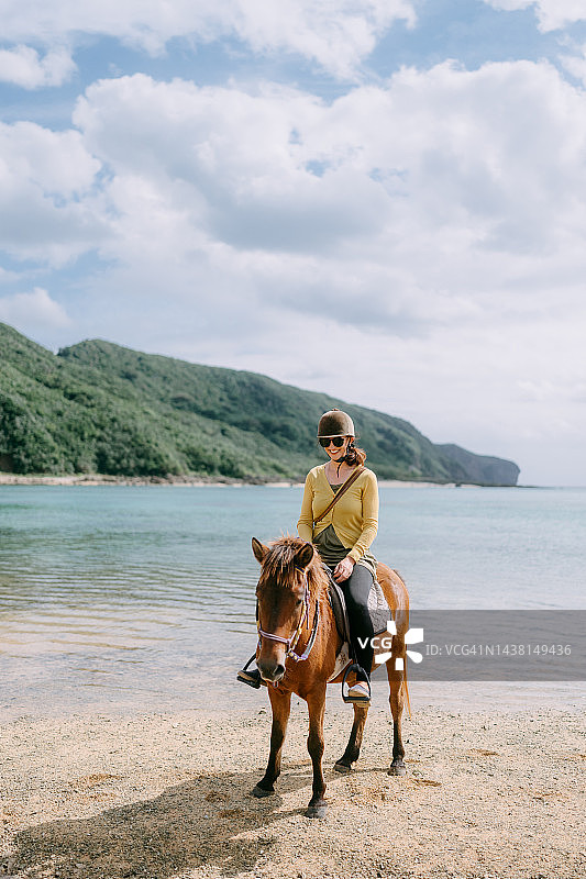 女人在海滩上骑马，与那国岛，日本图片素材