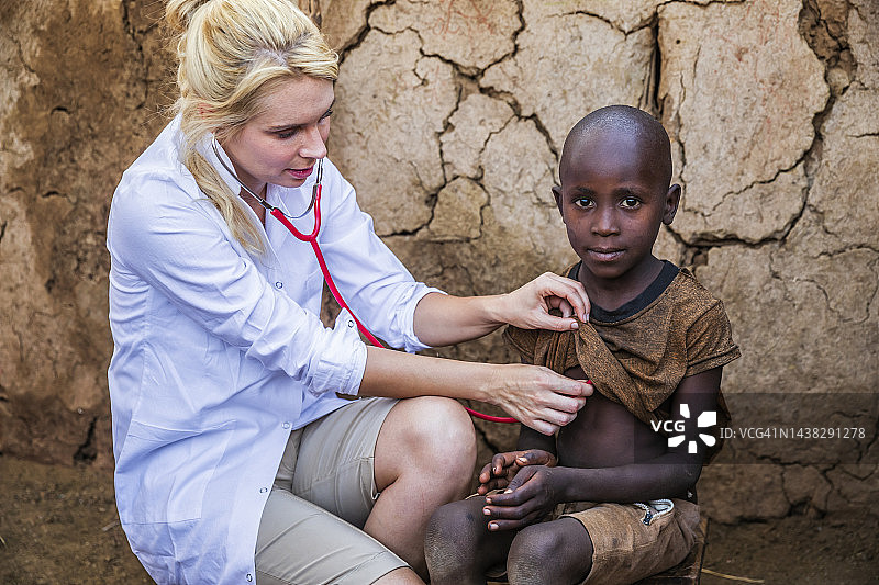 在肯尼亚小村庄，医生检查非洲男孩图片素材