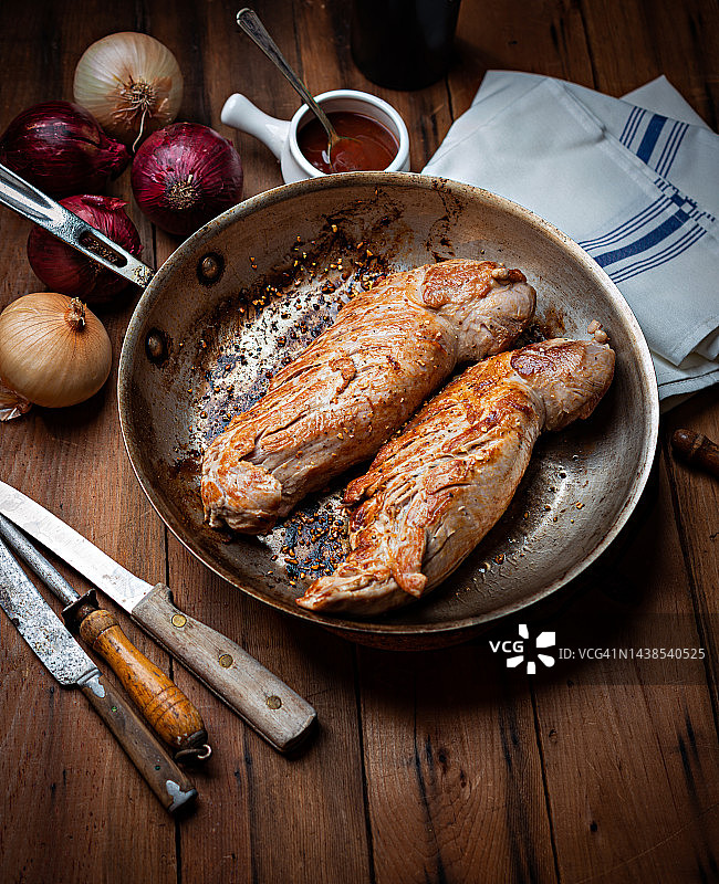 不锈钢锅上的美味里脊肉。图片素材