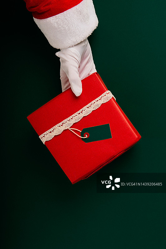 圣诞老人赠送红色圣诞礼物，绿色背景图片素材