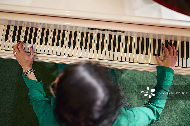 俯视：弹奏老式钢琴的女人图片素材