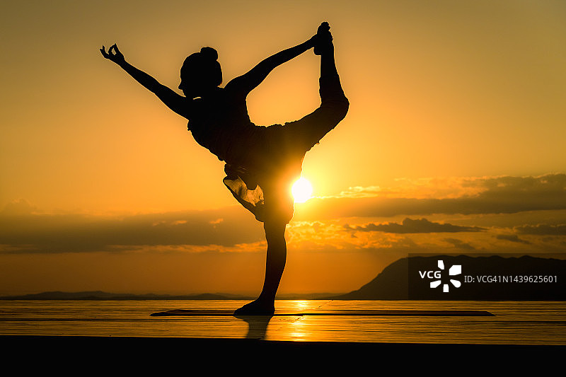 日落时分户外，女性剪影摆出舞蹈瑜伽姿势图片素材