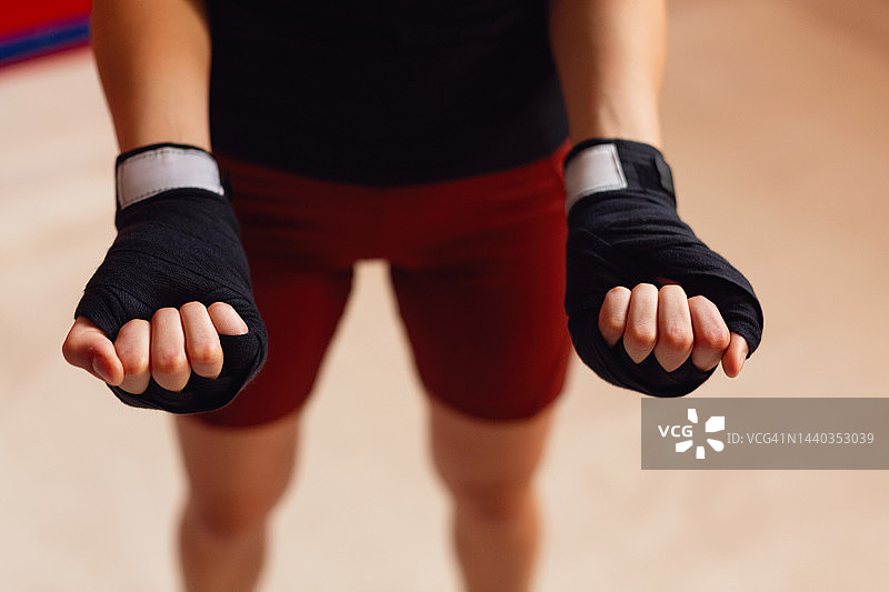 拳击训练前，一位身份不明的女拳击手在手上缠绷带图片素材