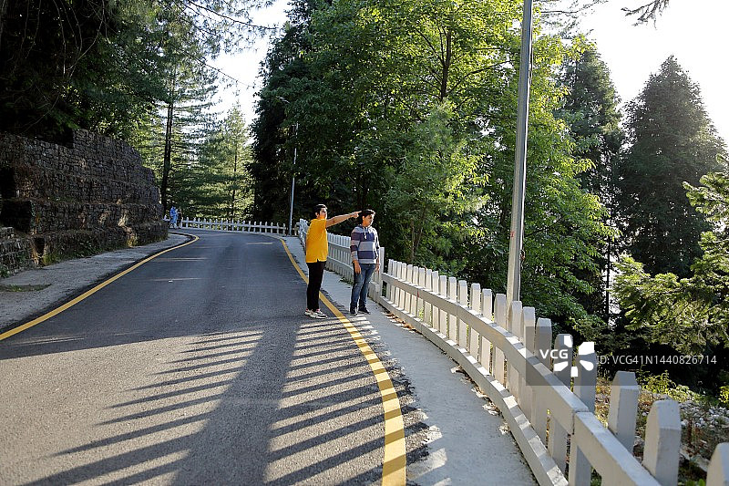 两位年轻人在路边欣赏美景图片素材