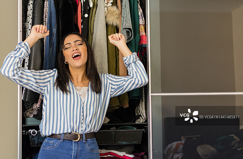 化着妆的年轻黑发女子在房间里跳舞。考虑聚会和购物。鞋子和女装时尚概念图片素材