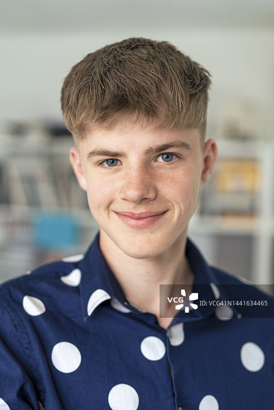 微笑金发少年穿着波点衬衫图片素材