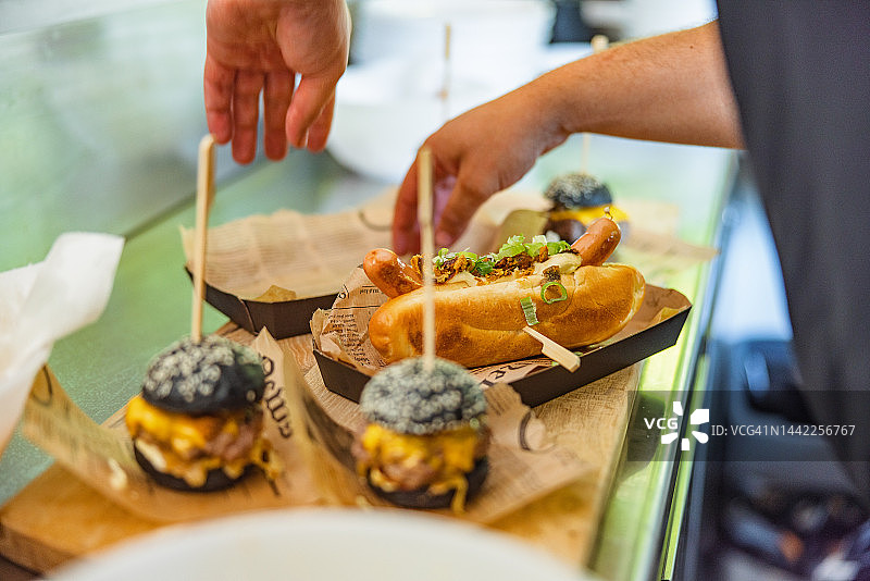 男厨师在厨房为快餐订单做最后的润色图片素材