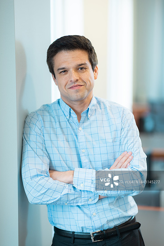 看向镜头，中性背景，放松自然的微笑，自信的肖像图片素材