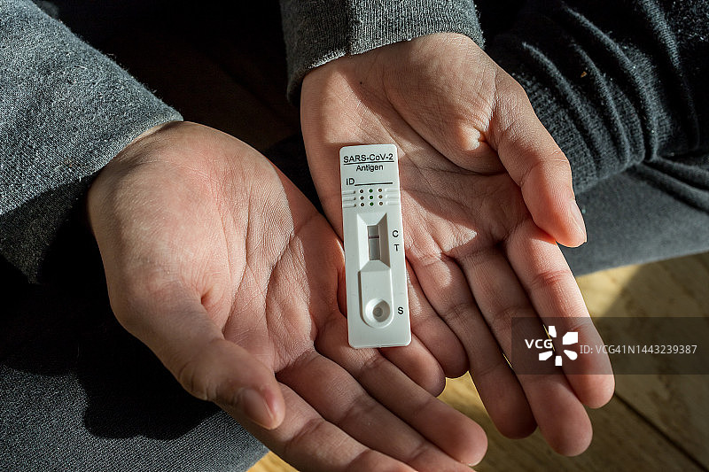 女人在家中手持快速诊断测试，结果为阴性特写图片素材