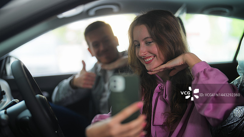 情侣在展厅新车里开心地自拍图片素材