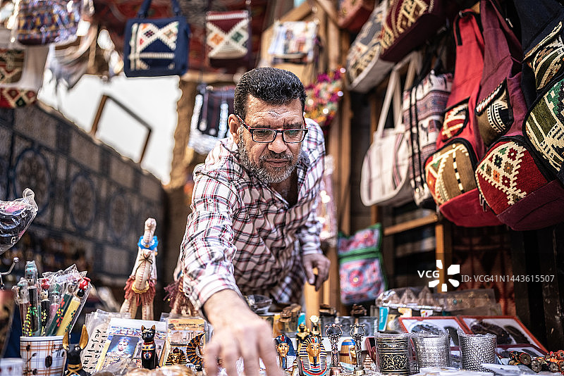 店主在店内整理纪念品图片素材
