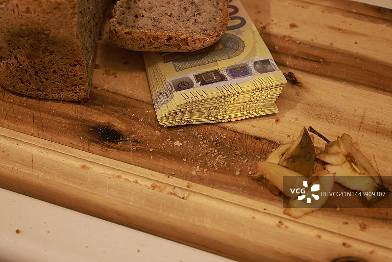 面包和200欧元纸币在砧板上图片素材