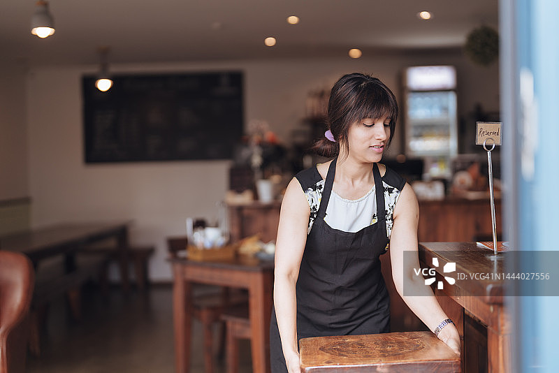 女服务员整理餐厅的桌子图片素材