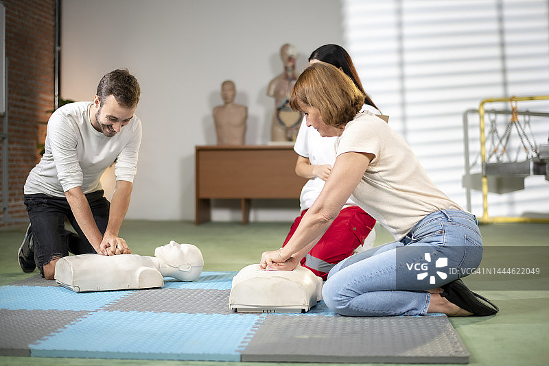 助教正在帮助一人从人体模型上正确进行心肺复苏图片素材