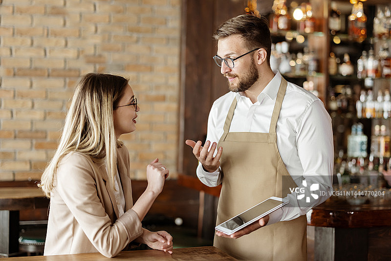 服务员使用平板电脑为顾客点餐图片素材