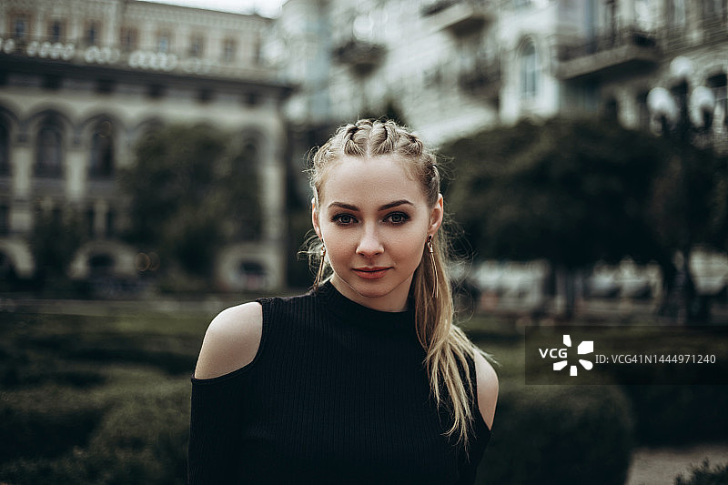 树木和复古建筑前的年轻女人图片素材