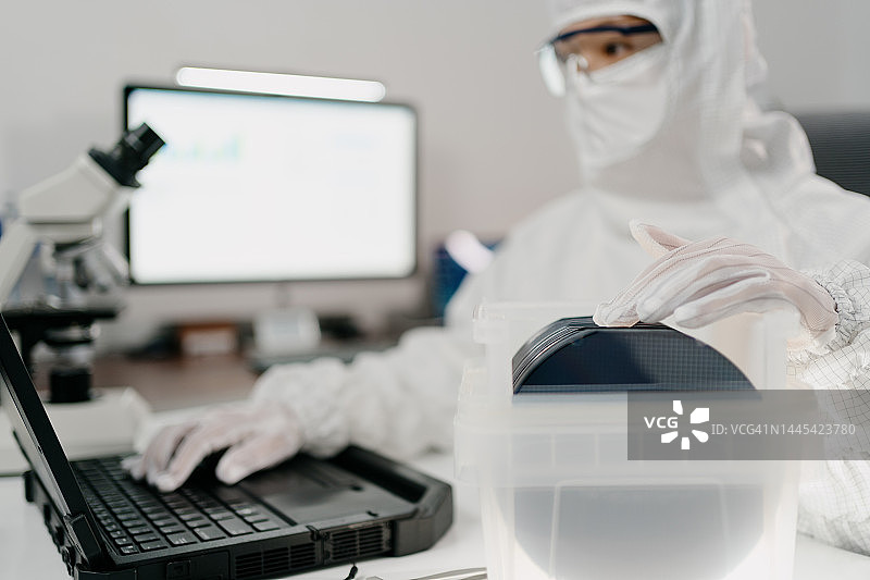 女工程师在实验室用电脑记录晶圆芯片图片素材