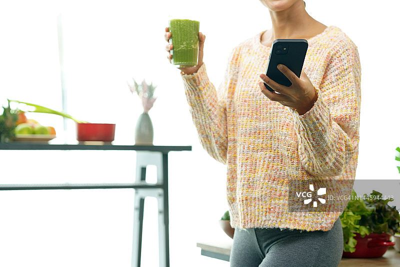 女人为了健康饮食喝绿色果汁图片素材