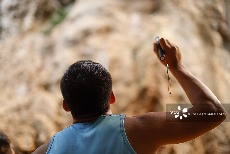 攀岩者使用激光笔指引攀爬路线图片素材