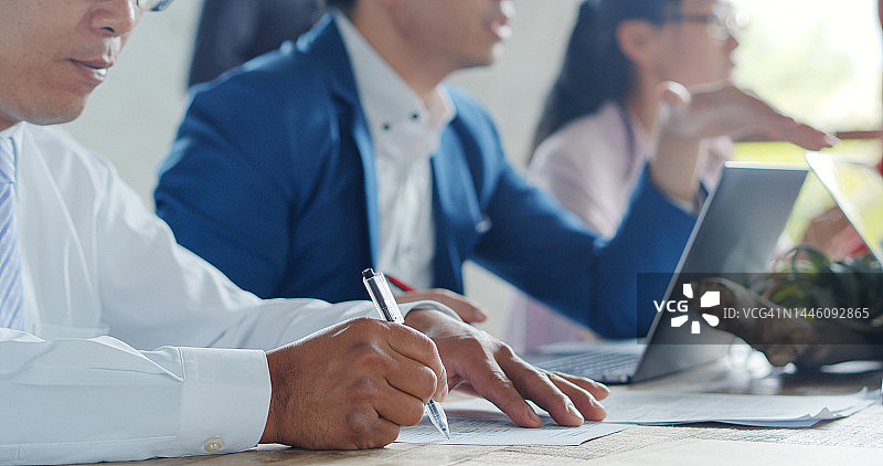 男人在会议桌上填写文件图片素材