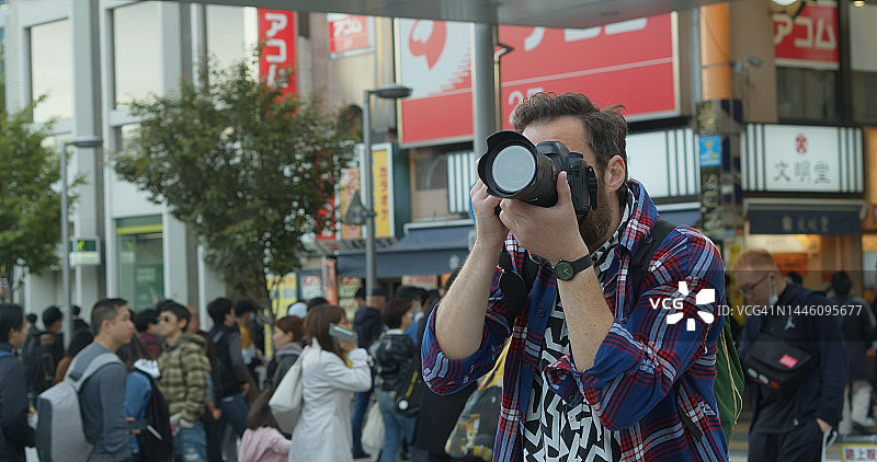 在东京街头拍照的白人游客图片素材