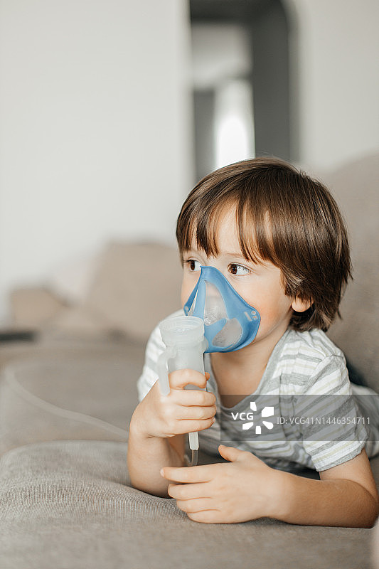小男孩在家用雾化器做雾化图片素材