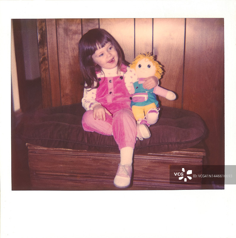 复古儿童写真，手持玩偶的儿童，20世纪80年代的儿童玩具图片素材