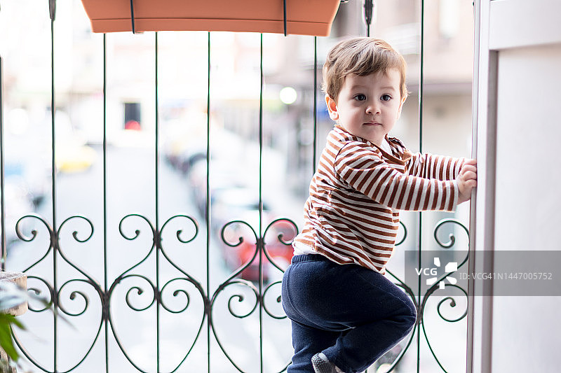 在隔离区凝视阳台的无聊小孩图片素材