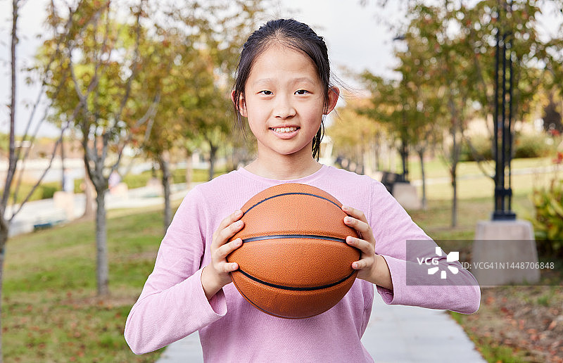 在户外手持篮球的女孩肖像图片素材